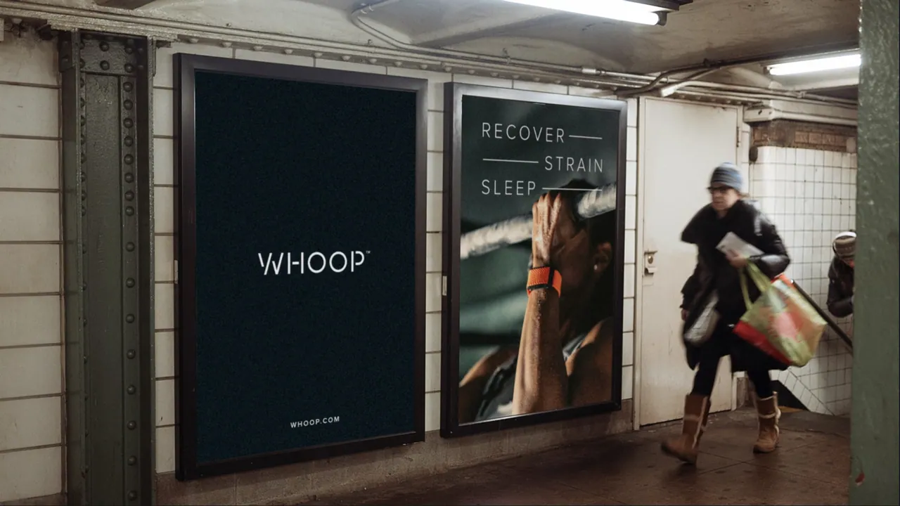 WHOOP: subway station posters reading “WHOOP” and “Recover, Strain, Sleep” as a commuter walks past.